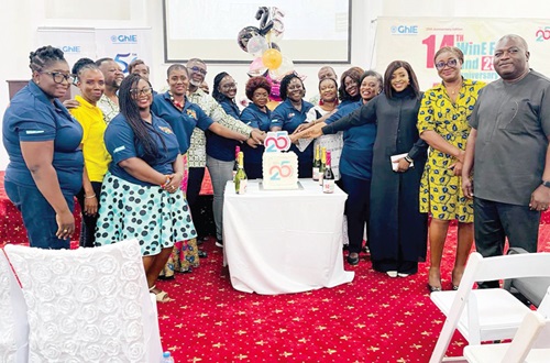WiNE members being assisted by Kwabena Bempong, the President of GhIE, and David Nyante, Executive Director of GhIE, to cut the 25th anniversary cake
