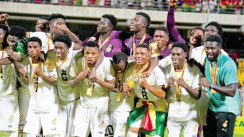 Players of the Black Satellites displaying their gold medals