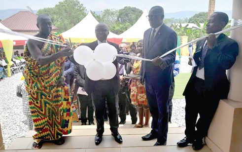 Justice George Akrofa Addae (2nd from left), Supervising High Court Judge, cutting the tape to officially inaugurate the facility. Looking on are Kwabena Pannin Nkansah (2nd from right), DCE for Atiwa East District, and Nana Frimpong Nkansah (left), Adehyehene of Anyinam. INSET: New circuit court building