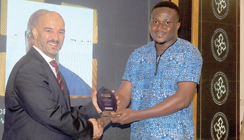 Atmane Boudjemia (left), Deputy Head of Mission, Embassy of Algeria, presenting the Media Brand of the Year Award - West Africa, to Justice Agbenorsi (right), a Reporter with the Daily Graphic, at the event. Picture: ESTHER ADJORKOR ADJEI