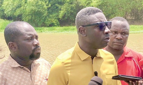 James Kofi Annan (middle), NDC parliamentary candidate for Effutu, addressing the media at the Ayensu River side