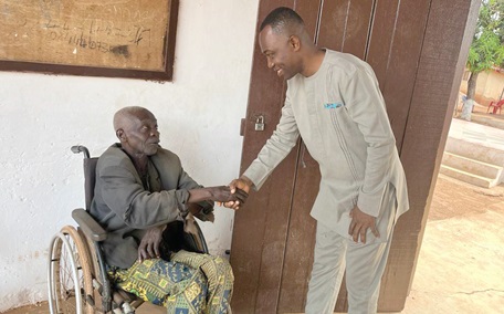 Anane Agyei (right), Executive Director, Busia Institute, in a handshake with one of the senior citizens he interacted with during the Ghana Month celebration