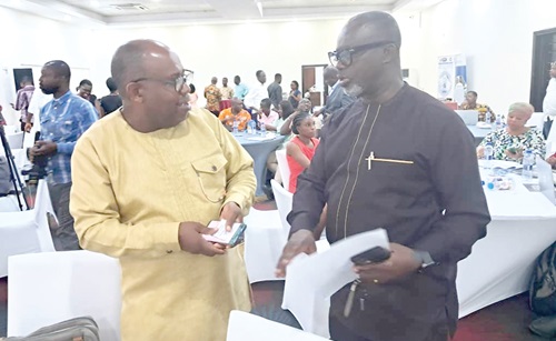 Dr Eric Asuman (right), Director-General of GMet, interacting with Prof. Leonard K. Amekudzi, Provost of the College of Science, Kwame Nkrumah University of Science and Technology
