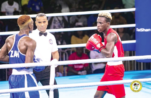 •  Samuel Takyi (right) competes against Zambian Emmanuel Katema in the final of the men’s 63.5kg weight category. 