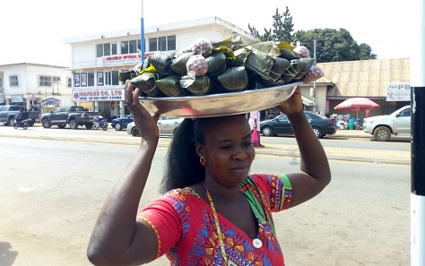 Some of the Nkyekyeraa wrapped in katemfa leaves. Inset: Abena Gyamea, one of the Nkyekyeraa sellers plying her trade on the street in Sunyani