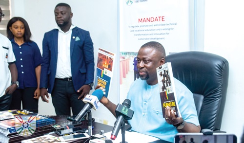  Dr Fred Kyei Asamoah displaying the Competency-Based Training curricula at the media engagement