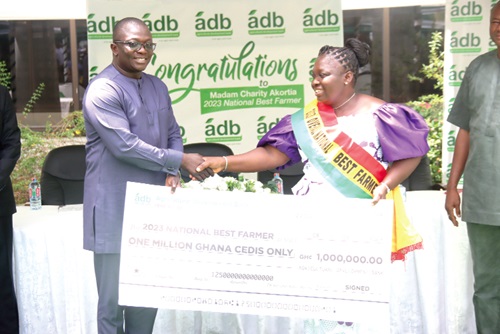 Dr Bryan Acheampong (left), Minister of Food and Agriculture, presenting a dummy cheque to Charity Akortia (right), National Best Farmer 2023. Picture: ELVIS NII NOI DOWUONA