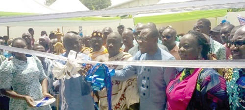 Dr Dacosta Aboagye (3rd from right) cutting the ribbon to inaugurate the NHIS office at Nuaso