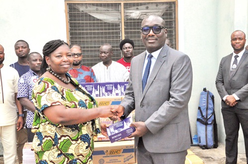 Yaw Acheampong Boafo (right), President of GBA, presenting the items to Isabella Regina Ayimey, North Tongu Director of Education 