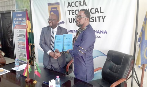 Prof. Amevi Acakpovi (left), acting Vice-Chanceller, ATU, exchanging the MoU with Prof. Hugh Keku Aryee, Vanuatu Trade Commissioner to Ghana