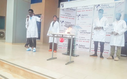 Students of Galaxy International School explaining an experiment at the 19th Annual Science and Makers' Fair