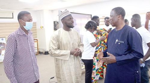 Dr Bright Mawudor (right), the Dean of the Wisconsin Business School, interacting with Umar English (middle), a Senior Officer at the Ghana Stock Exchange, who facilitated the lecture as Martin Tetteh Samadji (left), the Director of Internal Audit, the Wisconsin International University College, look on. 