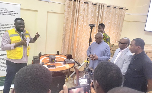 Bernard Makafui Agbelengar (left), Informatics Officer, GARID Project, briefing Osei Bonsu Amoah (3rd from right), Minister of State, Ministry of Local Government, Decentralisation and Rural Development, and other dignitaries on how the DJI Matrice 30 RTK Drone works. Picture: EDNA SALVO-KOTEY