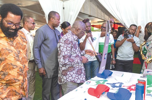 Dr David Nkansa-Dwemena (arrowed), KBTH Board Chairman, inspecting the anniversary paraphernalias during the launch. With him are Alfred Okoe Vandapuije (left), MP for Ablekuma South, and Dr Opoku Ware Ampomah (3rd from left), CEO KBTH