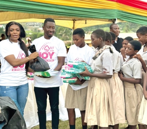 Joycelyn Tetteh (left), MP for North Dayi, presenting the items to the students