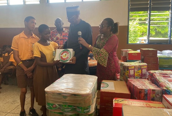  The Resident Representative of ECOWAS in Ghana, Ambassador Baba Gana Wakil (in black) presenting one of the items to the student leaders of the Dzorwulu Special School
