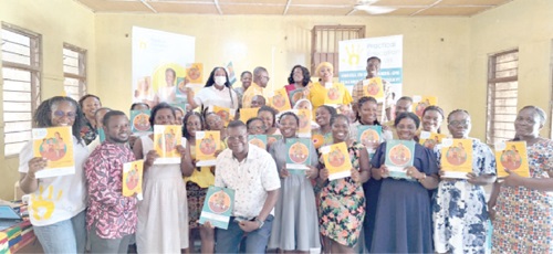 The participants displaying the teaching manuals