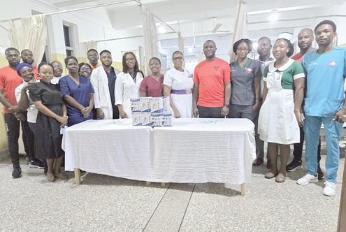 Emmanuel Afranie Jnr  (6th from right), founder of Coach Hene Sports Clubin, with some staff of the Stroke Unit of the Korle Bu Teaching Hospital after the donation
