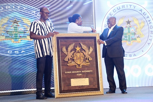  President Akufo-Addo receiving his award from Ursula Owusu-Ekuful (middle), Minister for Communications and Digitalisation, at the awards ceremony in Accra. With them is Dr Albert Antwi-Boasiako (left), Director-General, Cyber Security Authority, Ghana.  Picture: SAMUEL TEI ADANO
