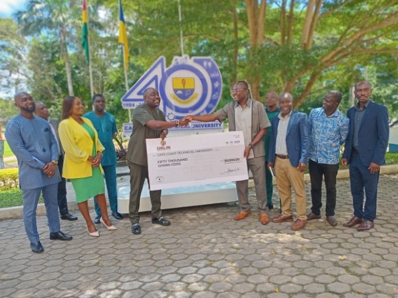 Managing director of Orlin Construction Ltd, David Odoi-(left)presenting a cheque to the Registrar of CCTU, Dr. Anthony Turkson.