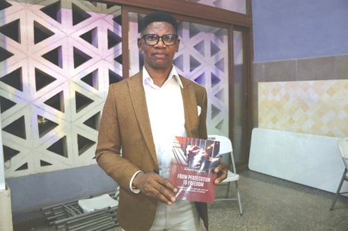  ACP (retd) Benjamin Agordzo, the Author, with a copy of the book after launch