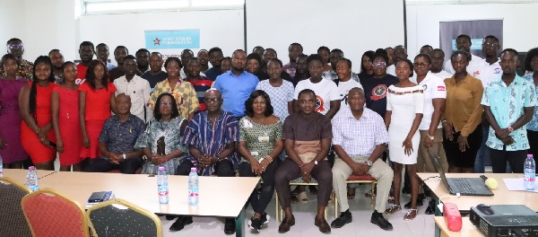 Raymond Danso (seated right), Project Manager in charge of Rights to Services of the STAR-Ghana Foundation together with other dignitaries and participants standing
