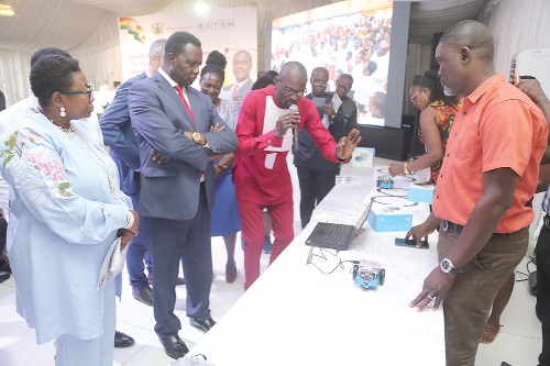  Emmanuel Ditamina (3rd from left), Regional Advisor on STEM, demonstrating the functions of some products to Dr Yaw Osei Adutwum (2nd from left), Minister of Education, at the event. With them is Olivia Serwaa Opare (left), Director of the National STEM Resource Unit. Picture: SAMUEL TEI ADANO