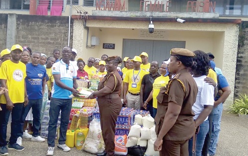  David Kwame Abotsi (left), Secretary of the Ghana National Tailors and Dressmakers Association, presenting items to ASP Sophia Ofori, officer in charge of the Nsawam Medium Security Female Prisons