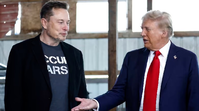 President Donald Trump offers his hand to Elon Musk back stage during a campaign rally at the Butler Farm Show grounds on Oct. 5  in Butler, Pennsylvania