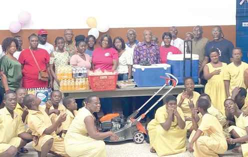 Members of the Michelle Naa Adjeley Mensah Foundation with some of the teachers, pupils of Dzorwulu Special School and the donated items. Picture: SAMUEL OHENE EWUR