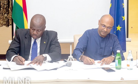 Samuel Abu Jinapor (left), Minister of Lands and Natural Resources, signing the FLEGT document, together with Irchad Razaaly, the EU Ambassador to Ghana
