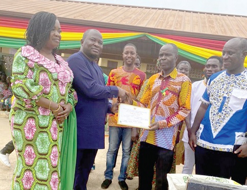 Alexander Akwasi Acquah (2nd from left), MP for  Oda, presenting a certificate to Hayford Yeboah, the overall best municipal farmer. With them are Joyce Adjoa Agyeiwaa (left), the MCE for Birim Central Municipality, and Isaac Mann (right), the Municipal Director of Agriculture 