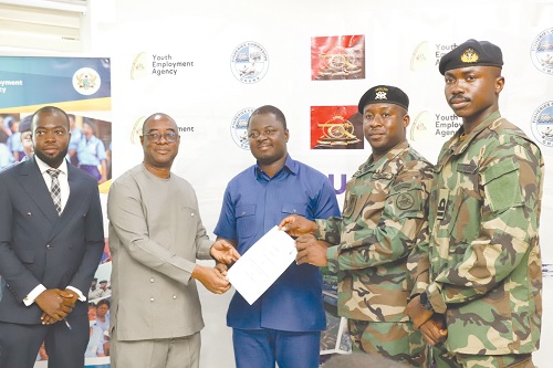 Kofi Baah Agyepong (3rd from right), Chief Executive Officer, Youth Employment Agency; Lt Col. Jalali D. Ibrahim (2nd from right), Commanding Officer, 66 Artillery Regiment, Ghana Armed Forces, displaying the MoU. Picture: EDNA SALVO-KOTEY