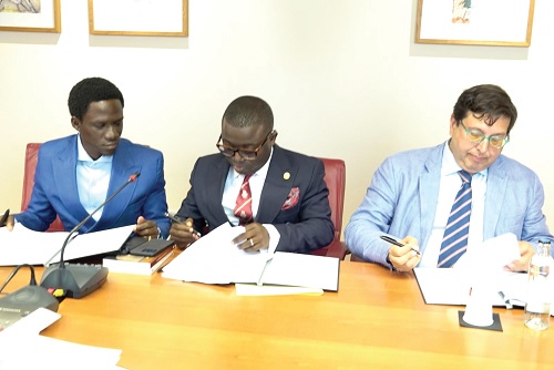 Charles Owusu (middle), CEO, Petroleum Hub Development Corperation, and José Segura Clavell (right), President of Casa África, signing the agreement