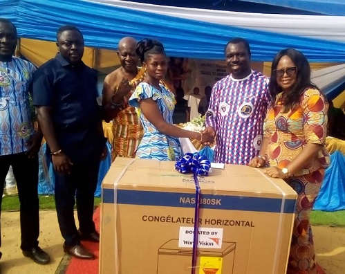 The guest speaker, Prof. Smart Sarpong (second from right) in a handshake with Cecilia Serwaa Anyan, the overall winner of the 2024 best teacher award.