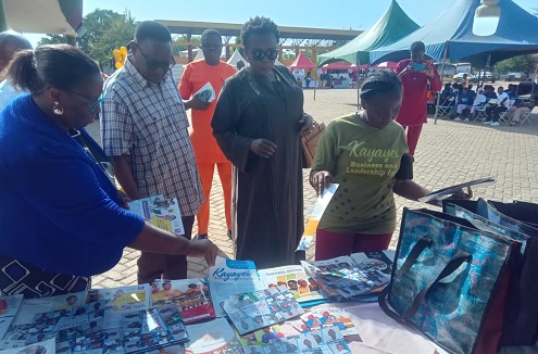 Rev. Aku Xornam Kevi (left), Executive Director, PAYDP, leading Madam Tangoba Abayage (2nd from right), former Upper East Regional Minister, and Rex Asanga (2nd from left), MCE for Bolgatanga, to inspect some items on display during the fair