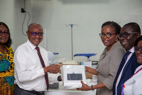 Alfred Kyungu (left), Africa West Area President of the church, handing over the items to Dr Yacoba Atiase, Director for NDMRC at the Korle Bu Teaching Hospital