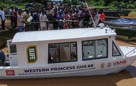  Kimberly Rosen (2nd from left), USAID/Ghana Mission Director, being supported by officials from the Ghana Health Service and traditional leaders to cut the ribbon to officially hand over boats to the community
