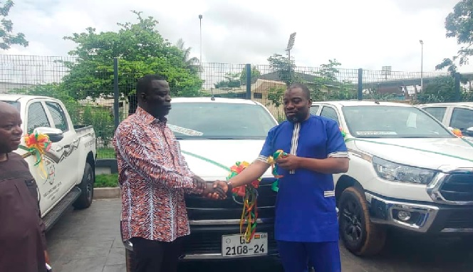 Ignatius Baffour-Awuah (left), Minister of Employment and Labour Relations, handing over the keys to the vehicles to Dawuda Ibrahim Braimah, acting Chief Labour Officer, Ministry of Employment and Labour Relations.