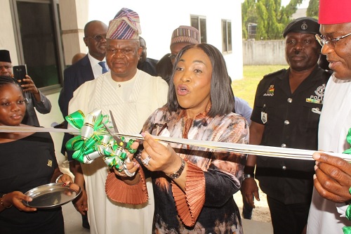 Front view of the building. INSET: Shirley Ayorkor Botchwey (middle), Minister of Foreign Affairs and Regional Integration, being assisted by Moses Ifedayo (left), the acting High Commissioner of Nigeria to Ghana,  to cut the tape 