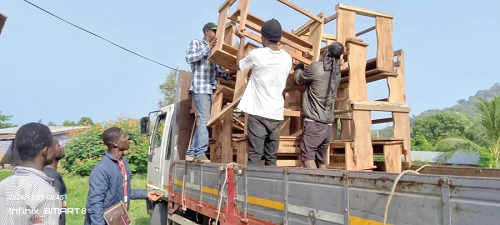 The desks being offloaded to the schools