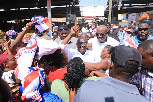  Dr Mahamudu Bawumia (arrowed), flag bearer of the New Patriotic Party (NPP), and Henry Quartey, the NPP parliamentary candidate for Ayawaso Central (behind), sandwiched by market women at the Mallam Atta Market when the two visited the market yesterday morning as part of Dr Bawumia's tour of some constituencies in Accra