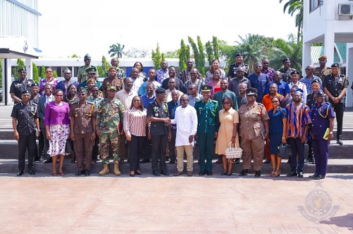  Dr George Akuffo Dampare, IGP, in a handshake with Professor Mamudu A. Akudugu, UTAG President, while other members of the task force and UTAG look on