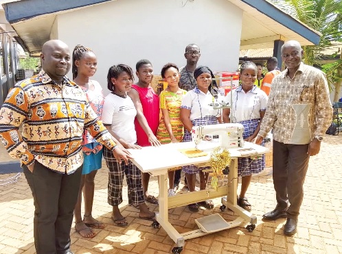 Prof. Yaw Fosu-Kusi (right), Board Chair of NADeF, with Kofi Baffour Domfeh (left), Underground General Foreperson, and some of the beneficiaries