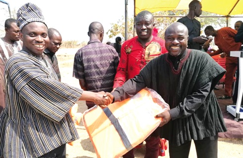 Jacob Ageke Tetteh (right), President, National Inland Canoe Fishermen Council, presenting fishing equipment to an inland fishing community leader