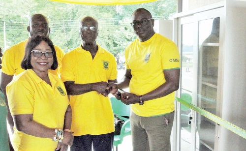 Gershon Kumor (middle), Executive Chairman of OMSU 74/76, presenting the keys to the bookshelves to Benjamin Yawo Dei, the headmaster. INSET: The bookshelves