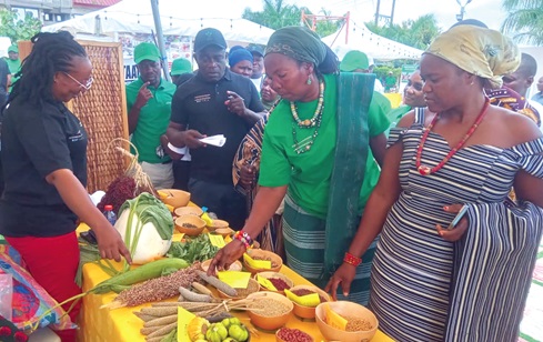  Hajia Alima Sagito (2nd from right), GaFFaP National President, with other dignitaries, inspecting some farm products during an exhibition as part of the event