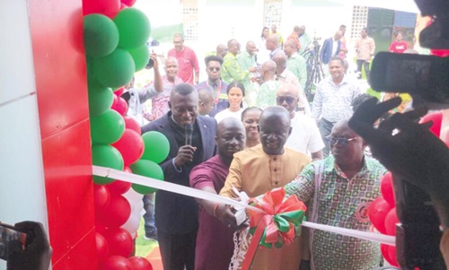 Samuel Larbi Darko (right), National President of LiSAG; Francis Manu Adabor (middle), MP for Ahafo Ano South; and Stephen Djaba (left), CEO of Geo-Tech Surveys Limited, cutting the tape to inaugurate the new LiSAG Head Office. INSET: A view of the new the head office of LiSAG.