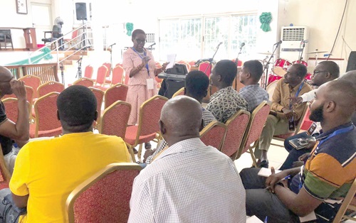  Gifty E. Annan-Myers (standing),  Director, Professionals Ministry, Anglican Dioceses of Accra, addressing the forum