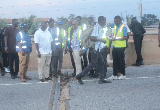 Francis Asenso-Boakye (4th from left), Minister of Roads and Highways, inspecting the damaged expansion joints at the Atomic overhead bridge. With him are other officials of the ministry. Picture: ERNEST KODZI
